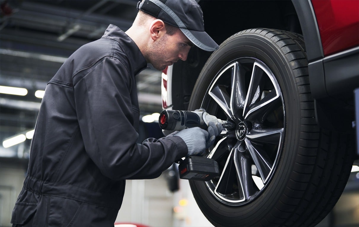 image of a man servicing a tire