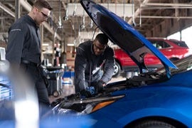 image of 2 men working on a car