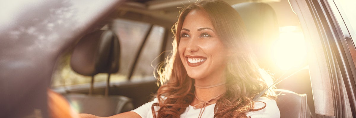 image of a woman driving and smiling